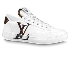 Women's Louis Vuitton Charlie Sneaker Buy Outlet Original: An image of a woman's foot wearing a shiny black, leather Louis Vuitton Charlie Sneaker.