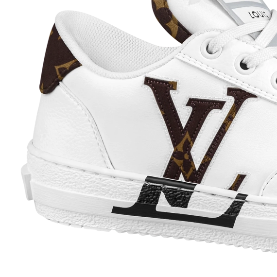 Shop Louis Vuitton Charlie Sneaker Outlet for Women: An image of a woman's foot wearing a white, leather Louis Vuitton Charlie Sneaker.