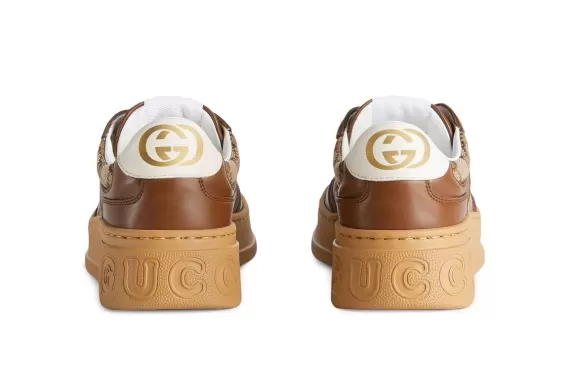 Get the newest Women's Gucci GG embossed low-top sneakers in Ebony-beige at our Outlet!