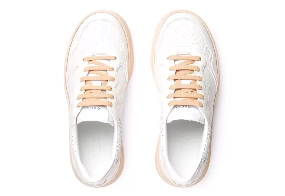 Find Women's Gucci GG Embossed Low-Top Sneakers - White/Peach at Outlet Prices.